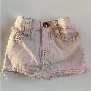 Light pink distressed denim skirt